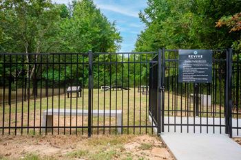 a gate to a park with a bench behind it